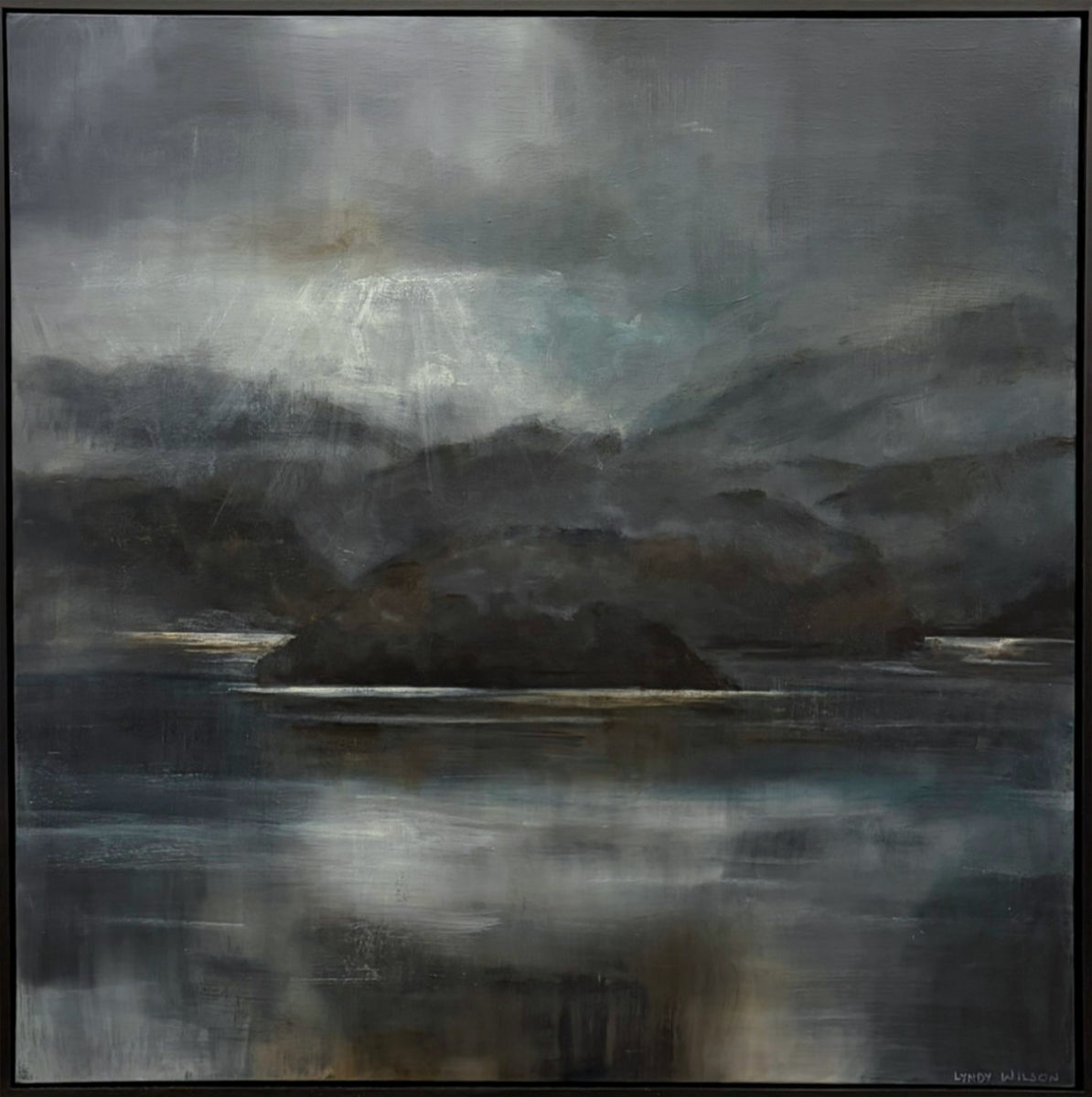 Acrylic painting of a moody riverscape by Lyndy Wilson, with dark hills beneath a clouded sky, shafts of light and muted reflections across still water