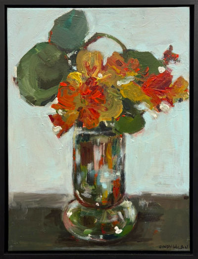 Acrylic painting of nasturtium flowers by Lyndy Wilson, with loose orange and red blooms and rounded green leaves arranged in a reflective glass vase against a pale background